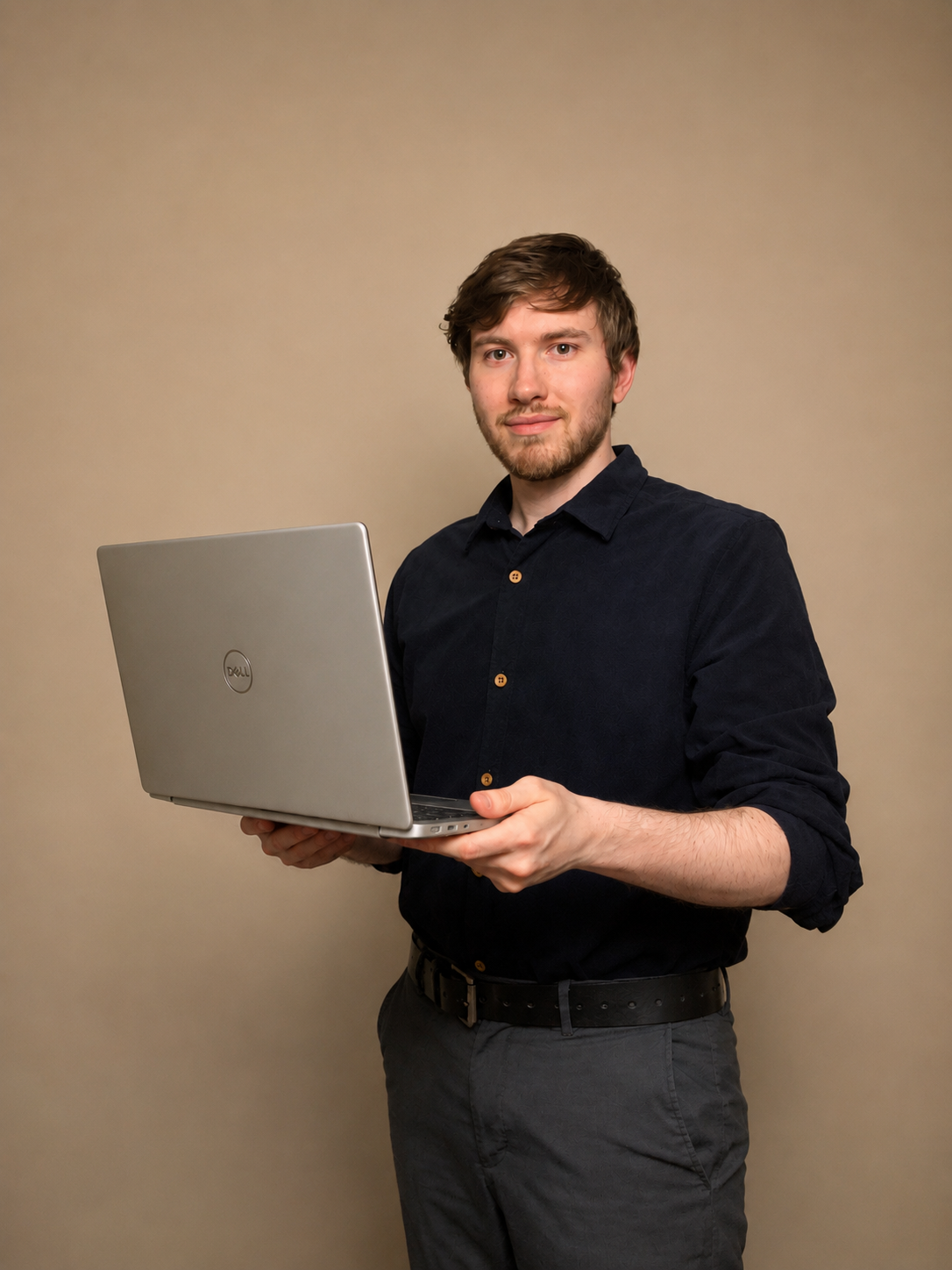 John holding a laptop